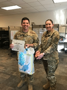 Photo of Army National Guard husband and wife with bag of baby essentials presented by Post 132