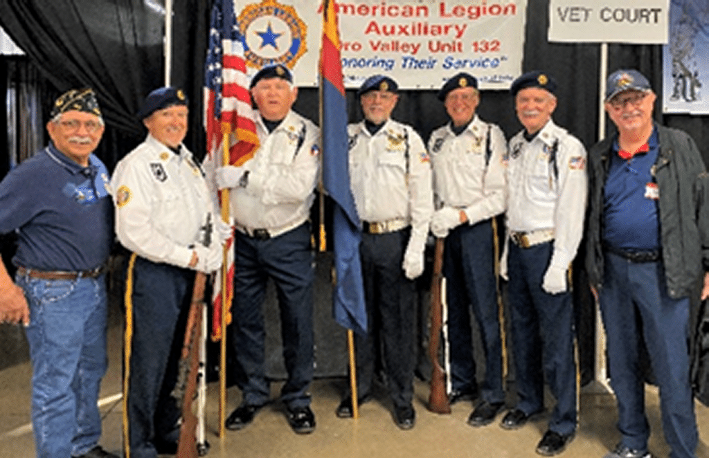 Five members of Post 132 color guard in full uniform, white shirts, blue hats and pants.