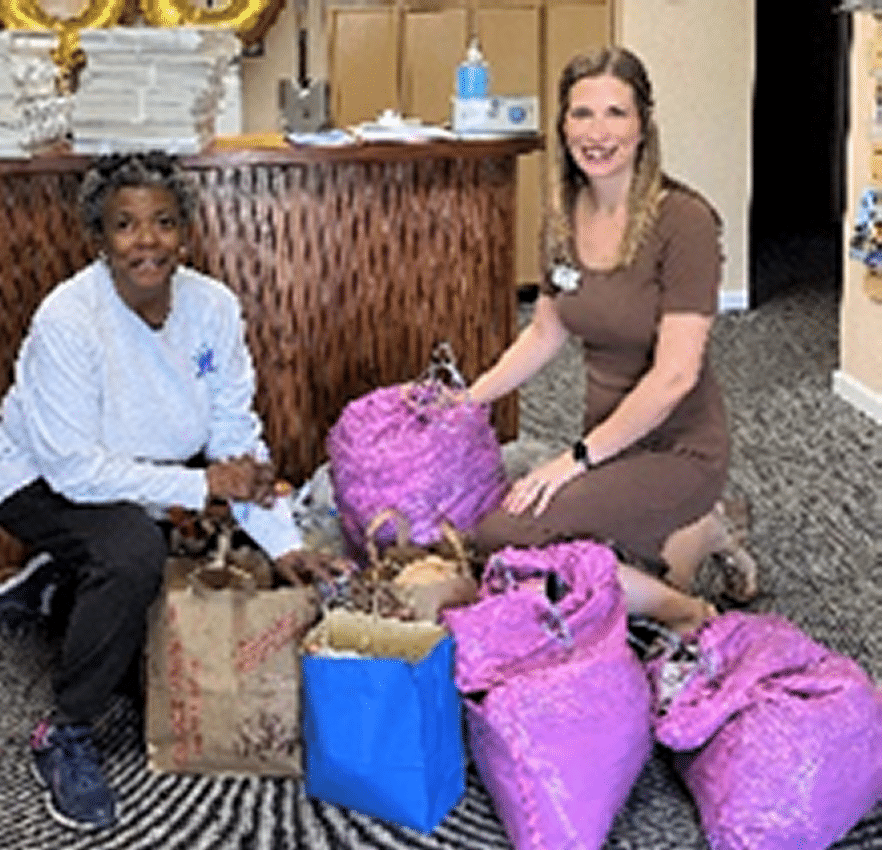 Volunteers with bags of clothing and toiletries for homeless veterans.