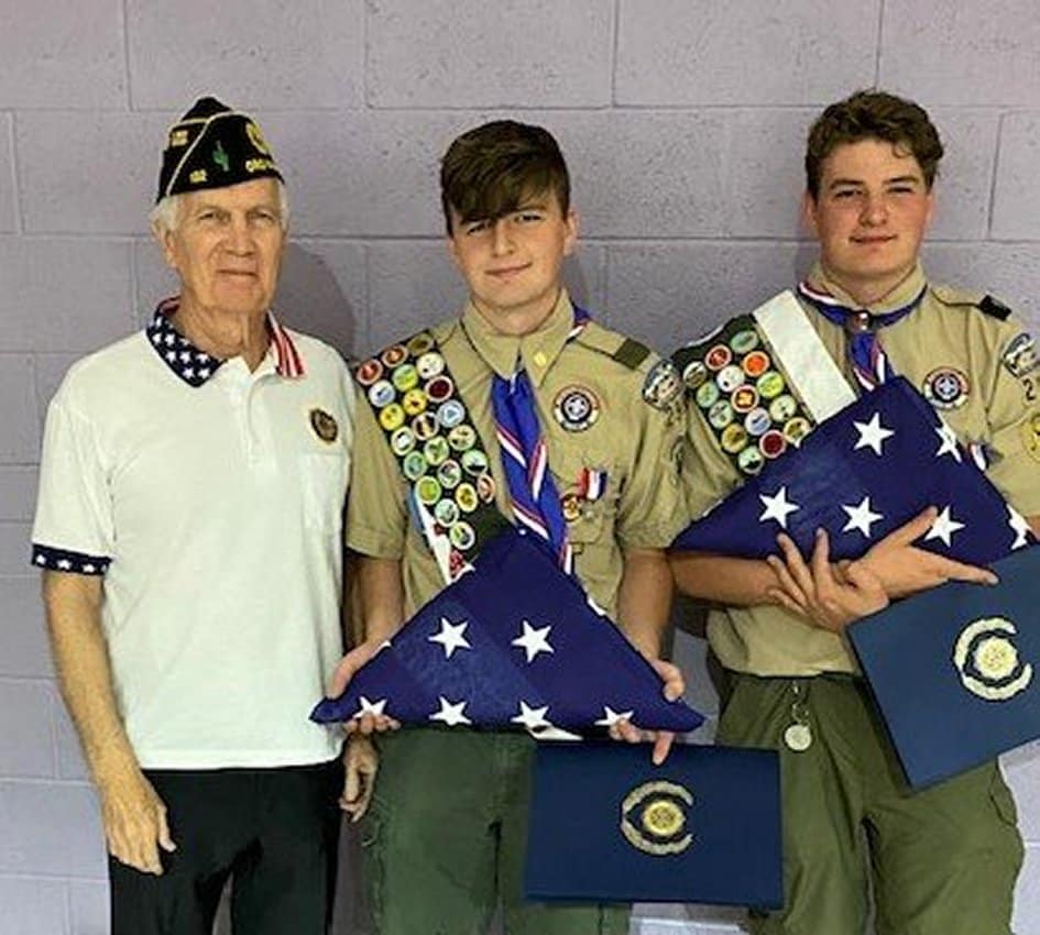 Post 132 Flags for Eagle Scouts representative Danny Lemon with two Boy Scouts holding United States flags.