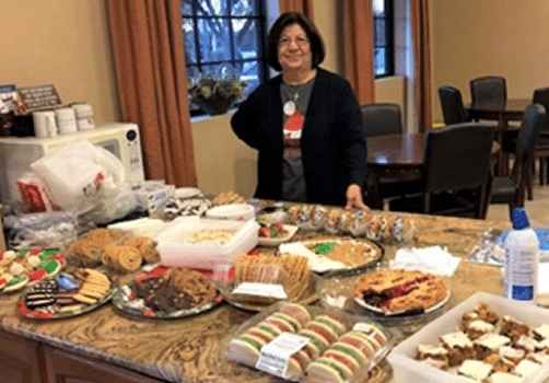 December Post Dinner Deserts on table with Auxiliary Unit member in background.