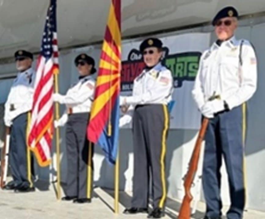 Four members of Post 132 color guard in full uniform holding a United States and Arizona flags.