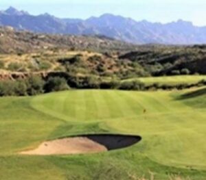 View of sand trap and fairway on a golf course.