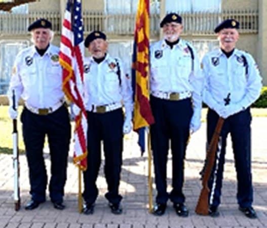 Four members of Post 132 Color Guard team holding United States and Arizona flags.