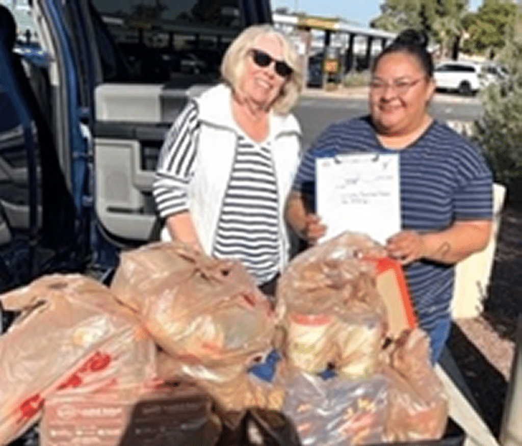 Auxiliary unit 132 member presenting food items to a representative of the Veterans Pantry.