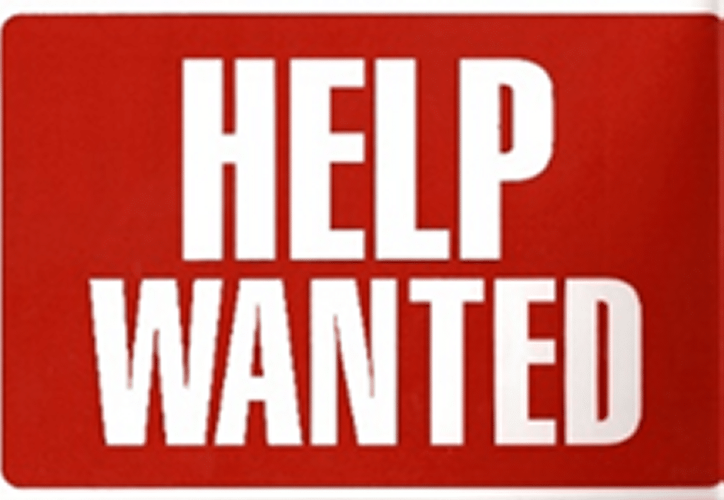 Help wanted sign, white lettering on red background.