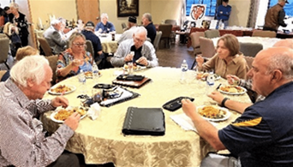 Members of Post 132, Auxiliary Unit and family members sitting at tables for an annual dinner.